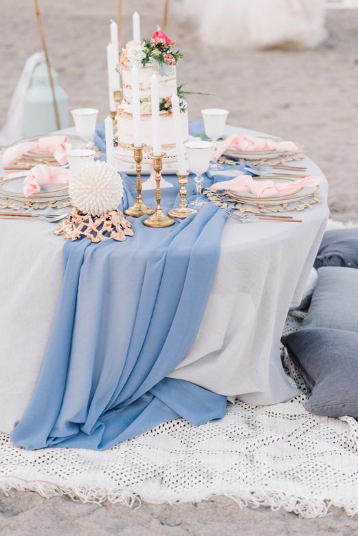 a-chic-beach-wedding-tablescape-with-a-blue-runner-pink-napkins-a-naked-wedding-cake-topped-with-blooms-and-white-candles Blue Silver Wedding Invitation Design